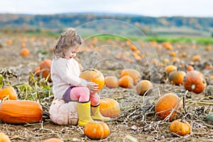 Little girl farming on pumpkin patch