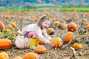 Little girl farming on pumpkin patch