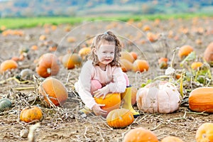 Little girl farming on pumpkin patch