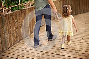 Little girl, father and holding hands with parent for bonding, adventure or fun field trip. Rear view of young child or