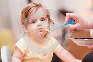 Little girl feeding from a spoon