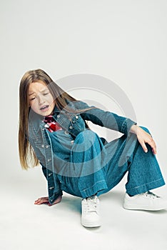 The little girl fell. Kid shows emotion hurt. frustrated child. Studio photography