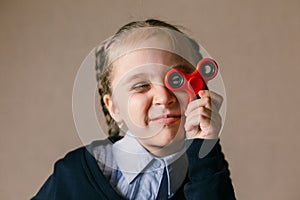 Little girl with Fidget Spinner held up to his eyes