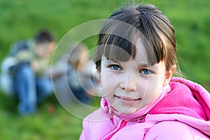 Little Girl in Field with Playmates