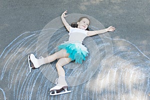 Little girl figure skating at imaginary skating rink arena