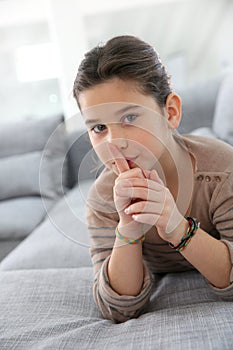 Little girl with finger on her mouth, keep quiet