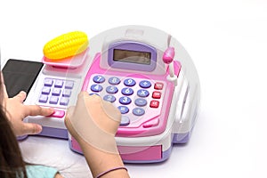 Little girl fingers pressing toy calculator