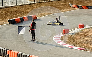 Little girl is finishing the ride with Go- Kart car in a playground racing track