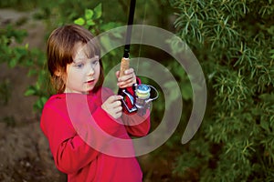 Little girl fishing with spinning