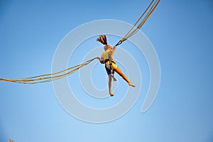 Little girl flies on elastic bands and jumps on a trampoline