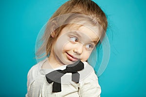 Little girl flirting and coquet, turns back, close-up portrait photo of funny child.