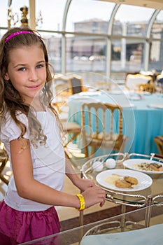 Little girl in floating restaurant with serving
