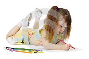 Little girl on floor drawing with crayons