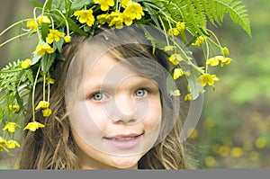 Little girl in flowers wreath