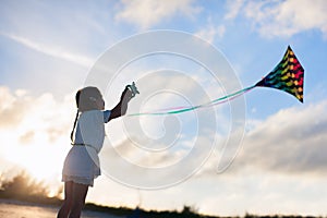 Little girl flying a kite