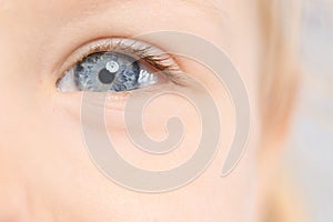 Little girl, focus on eye. Visiting children`s doctor