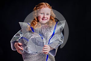 Little girl in foil diy space suit on a black background in the studio July 20, 1969 day of landing on the moon, child