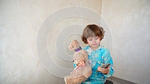 Little girl with friend listening music on phone.