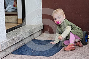Little girl in front of door