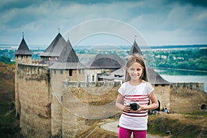 Little girl in front of Khotyn Fortress photo