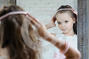 Little girl front the mirror