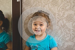 Little girl in front of a mirror