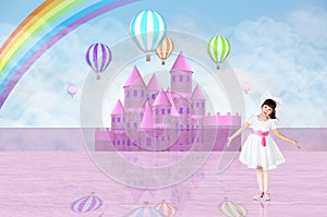 Little girl in front of a pink fairy castle