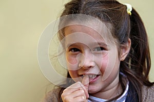 Little girl with the front tooth dangles photo