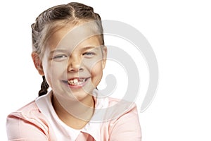 A little girl without a front tooth is laughing. Isolated over white background. Close-up