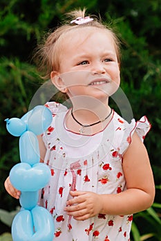 Little girl with funny hair with toy balloon