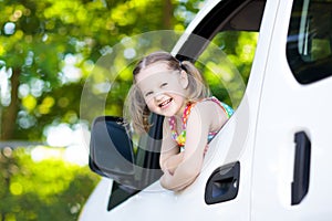 Little girl sitting in white car