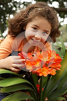 Little girl in a garden of clivia miniata photo