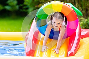 Little girl in garden swimming pool