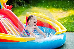 Little girl in garden swimming pool