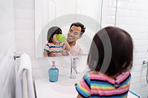 Little girl gargle after brush her teeth