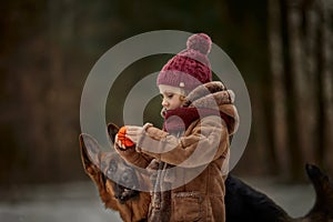 Little girl with German shepherd 6-th months puppy at early spring