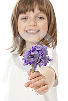 Little girl giving a bouquet