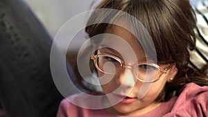 Little girl with glasses talking slowly