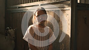 Little girl in goat stall