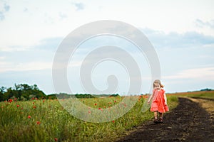 Little girl goes in dirty dirt road after rain.