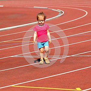 A little girl goes in for track and field athletics at the stadium