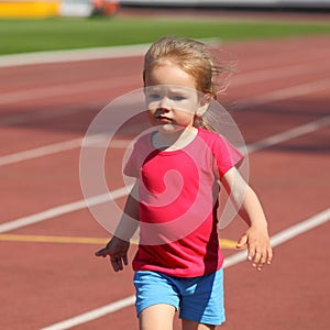 A little girl goes in for track and field athletics at the stadium