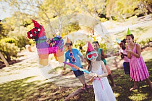 Little girl is going to broke the pinata for their birthday