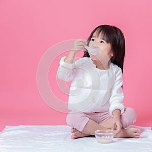 Little girl going to eat food by plastics spoon