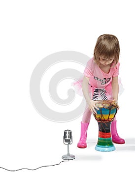 Little girl going to play on Djembe