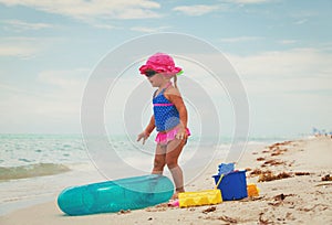 Little girl going to swim at beach