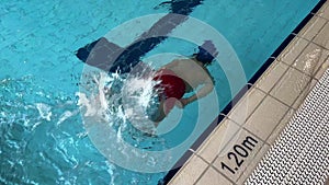 Little girl going underwater in swimming pool