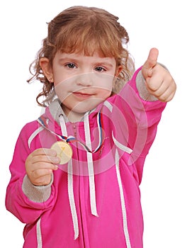 Little girl with golden medal and thumb up