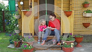 Little Girl with Grandmother Drawing Outdoors