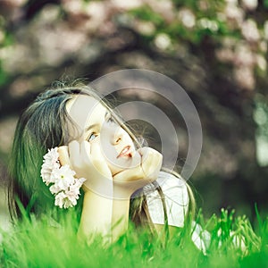 Little girl on grass in bloom